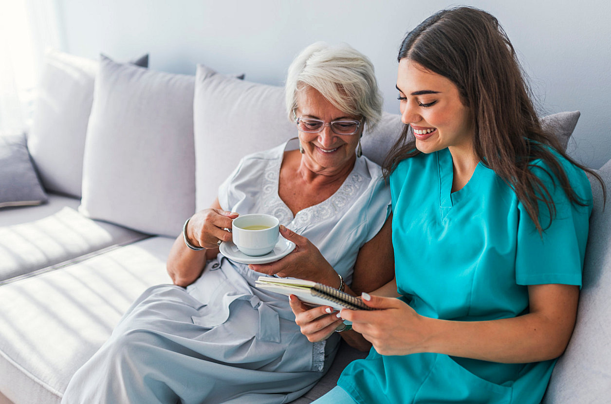 caregiver and senior reading something