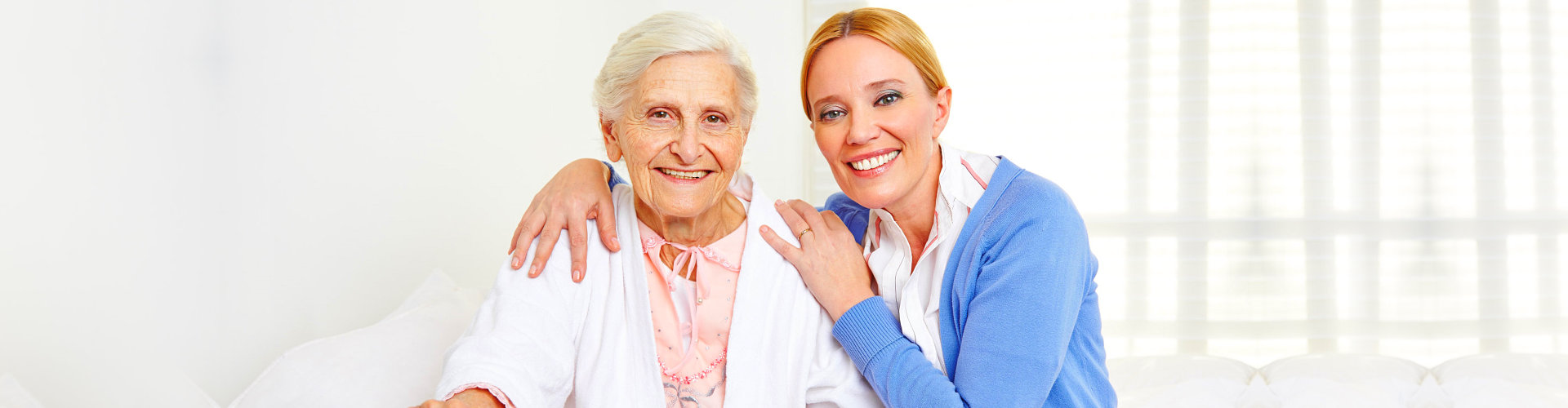 caregiver and senior woman smiling